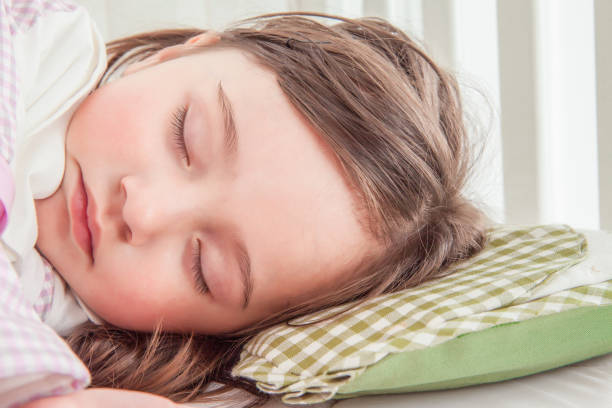 istock Little cute girl sleeping in bed 1131171994
