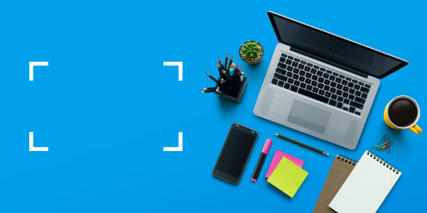 Office workplace with laptop, notebook, office supplies and stationery on blue background. Solution, business planning, creative, design, learning, start up or working flat lay top view concept.