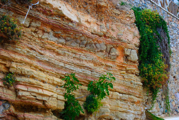 different layers of soil and a wall of bricks in Sisi, Crete, Greece