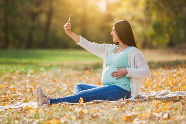 istock Pregnant woman in park 1131173129