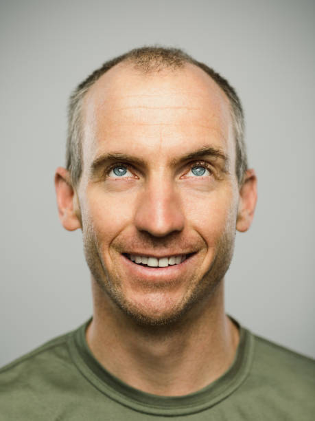 istock Portrait of real caucasian man with happy expression looking up 1131177367