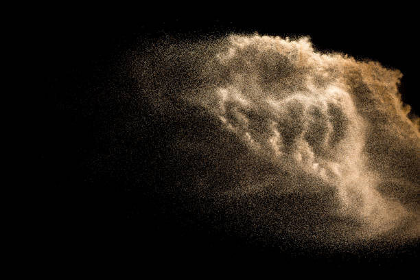 istock Golden sand explosion isolated on black background. Abstract sand cloud. Golden colored sand splash against dark background. Yellow sand fly wave in the air. 1131178138