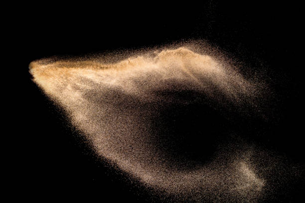 istock Golden sand explosion isolated on black background. Abstract sand cloud. Golden colored sand splash against dark background. Yellow sand fly wave in the air. 1131178162