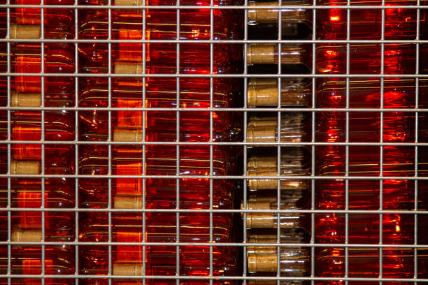 bottles with light pink wine are stored in a skeleton box