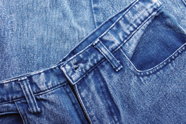 istock Background jeans, blue denim texture fabric with a seam of fashionable design. Empty pattern copy space 1131179779