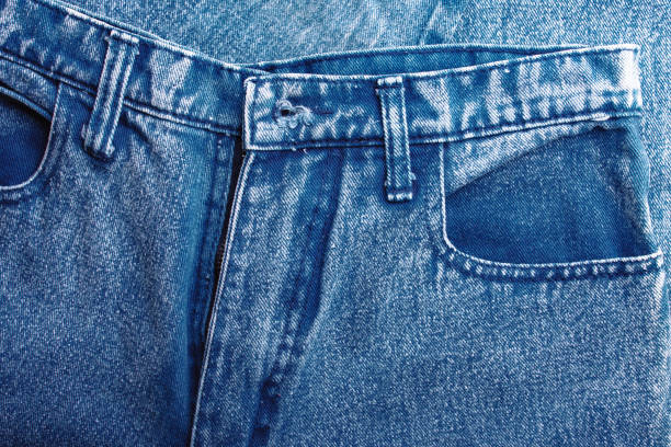 istock Background jeans, blue denim texture fabric with a seam of fashionable design. Empty pattern copy space 1131179786