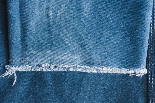 istock Background jeans, blue denim texture fabric with a seam of fashionable design. Empty pattern copy space 1131179828