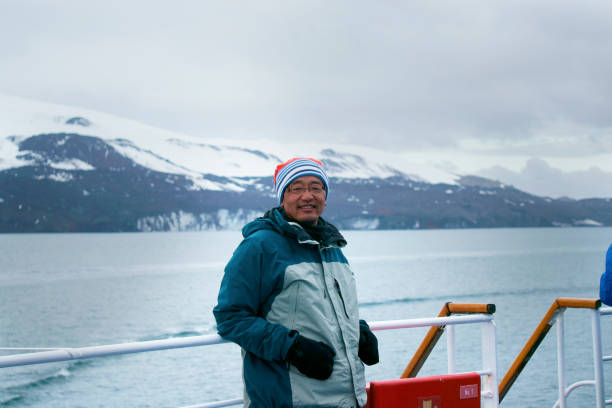 istock Man views at the glacier on the boat, Antarctica 1131180082