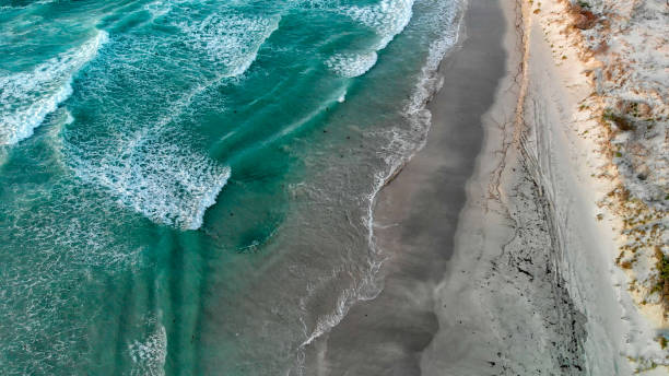 istock Waves on the beach, overhead aerial view 1131180807
