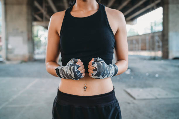 Muay Thai woman fighter with handwraps. Thailand, Bangkok