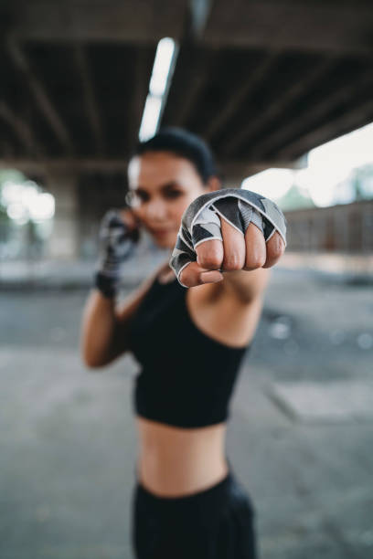 istock Powerful young woman punching 1131181453