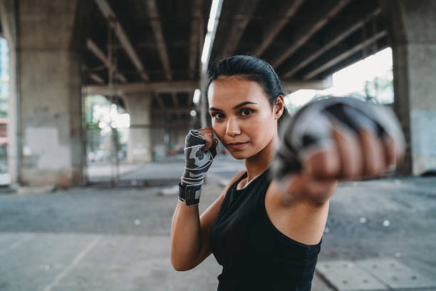 istock Powerful young woman punching 1131181464