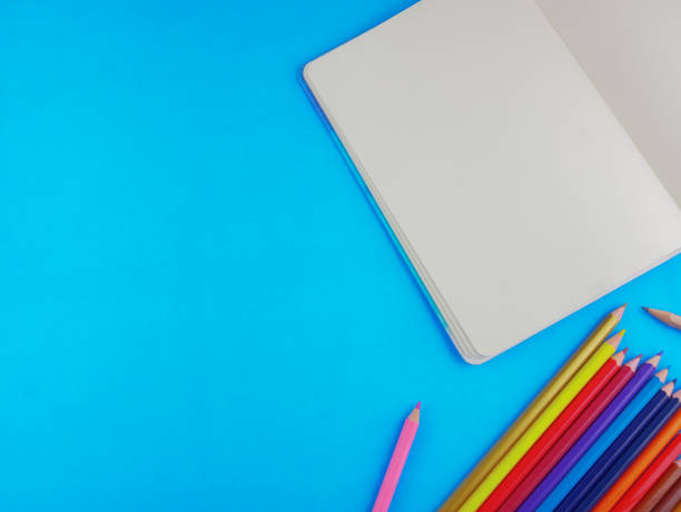 istock Flat lay,top view stationery including color pencils and notebook with copy space 1131182792