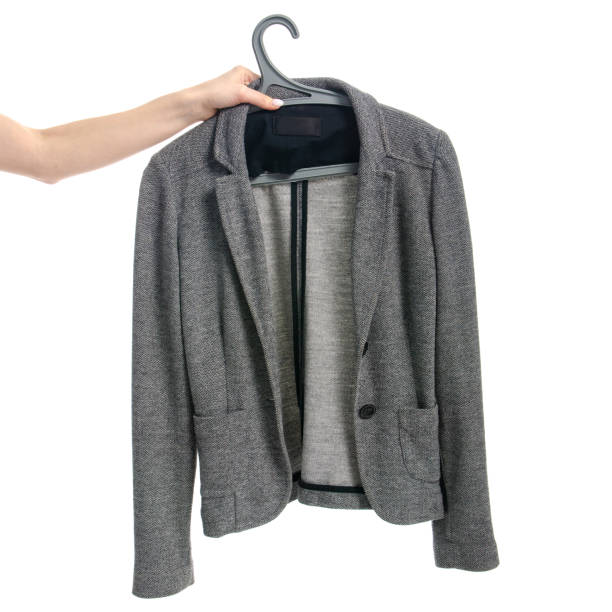 istock Clothes gray jacket on a hanger in hand 1131183712