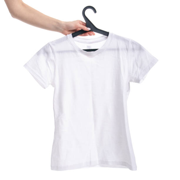 istock White t-shirt on a hanger in hand. Isolation 1131183720