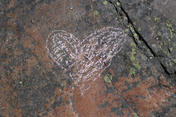 istock Pink Heart Drawn on a Red Rock Surface 1131184264