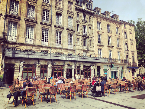 Bordeaux, France - May 01, 2018: People enjoying food in outdoors cafe in Bordeaux