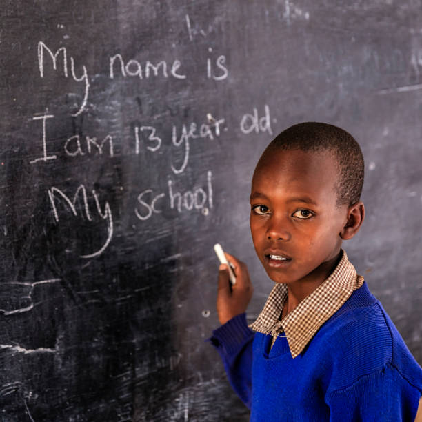 istock African young boy is learning English language, Kenya 1131188655
