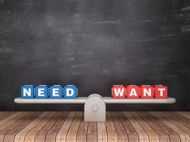 istock Seesaw Scale with NEED WANT Cubes on Chalkboard Background - 3D Rendering 1131189273