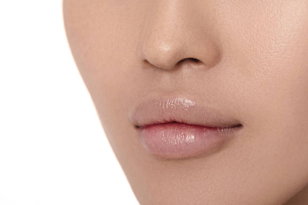 Female lips after augmentation procedure. clean skin. Female lips after augmentation procedure close-up. clean skin. big fat lips stock pictures, royalty-free photos & images
