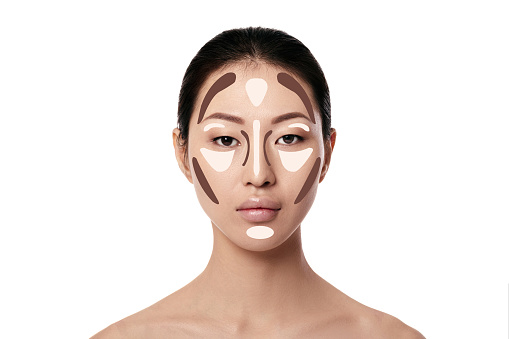 Contouring. Make up asian woman face on white background. Contour and highlight makeup. Professional face make-up sample