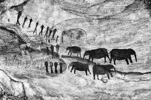 San rock art at the Stadsaal Caves in the Cederberg Mountains in the Western Cape Province. Elephants and people are visible are visible. Monochrome