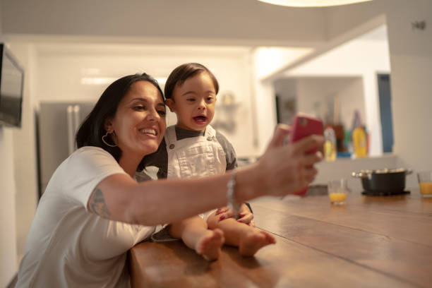 istock Mother and down syndrome son taking a selfie at home 1131194159
