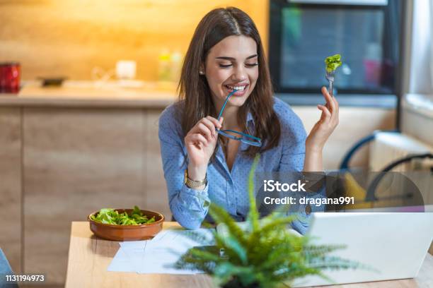 Young Business Woman Eating Salad At Home Stock Photo - Download Image Now - Eating, Eyeglasses, Salad