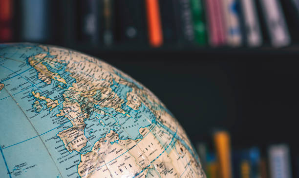 Close up on desktop globe. Europe and Northern Africa. In background out of focus books on shelves Old desktop globe in office close up north africa photos stock pictures, royalty-free photos & images