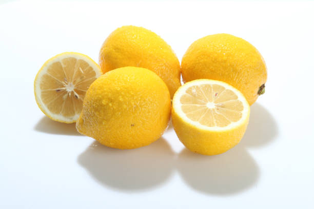 istock Lemons with leaves on a light background. 1131195551