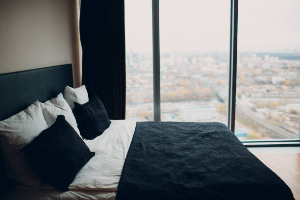 istock black bed with black and white linens 1131196387