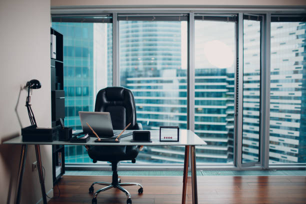 istock Modern comfortable and stylish chair, located by the window overlooking the skyscraper. 1131196405