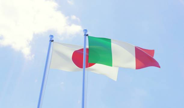 istock Japan and Italy, two flags waving against blue sky 1131196789