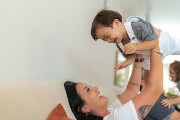 istock Mother picking up her Down Syndrome Son at home 1131198011