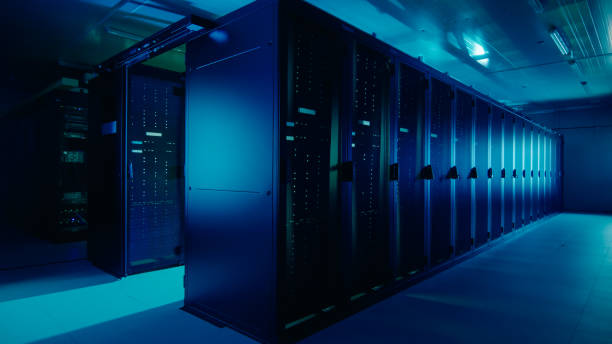 istock Shot of a Working Data Center With Rows of Rack Servers. Led Lights Blinking and Computers are Working. Dark Ambient Light. 1131198068