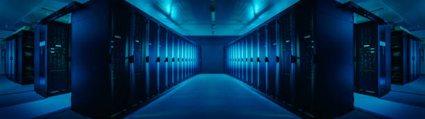 wide-angle panorama shot of a working data center with rows of rack servers. blue led lights blinking and computers are working. dark ambient light. - network server rack computer mainframe imagens e fotografias de stock