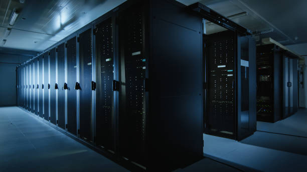 istock Shot of a Working Data Center With Rows of Rack Servers. Led Lights Blinking and Computers are Working. Dark Ambient Light. 1131198083
