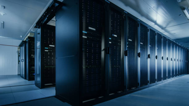 shot of a working data center with rows of rack servers. led lights blinking and computers are working. - cyberspace support computer assistance imagens e fotografias de stock