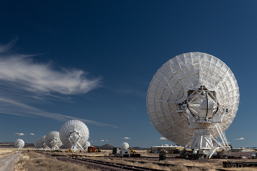Very Large Array line of radio astronomy telescopes seen from the rear, science technology, horizontal aspect
