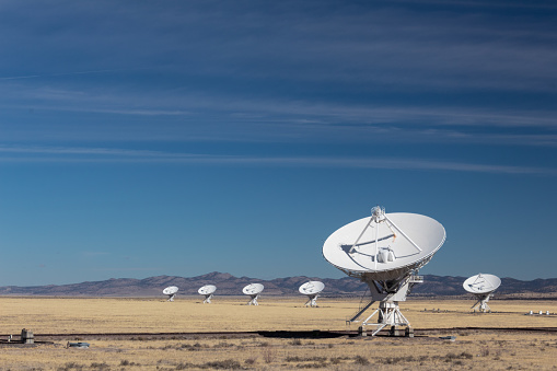 Very Large Array of radio astronomy observatory dishes in winter, science and technology, horizontal aspect