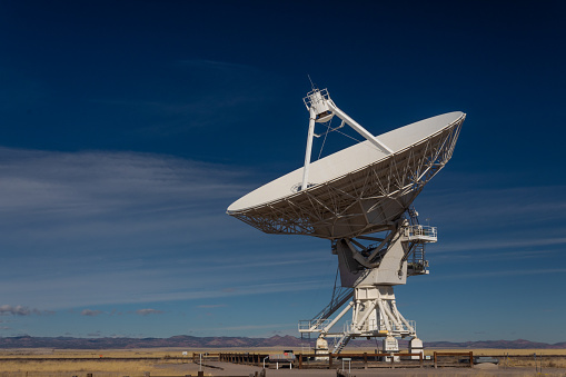 Very Large Array VLA radio antenna dish on pad in the New Mexico desert listening to the cosmos, horizontal aspect