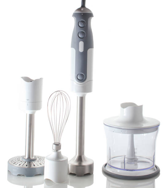istock Electric hand mixer. Set of nozzles and  containers for blender. Isolated objects on a reflective surface 1131203334