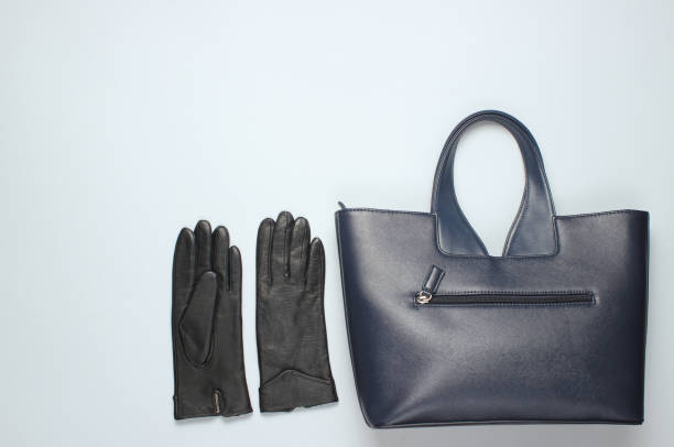 istock Leather bag, gloves on a gray background. Top view, minimalism 1131203514