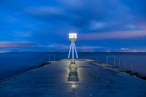 Klampenborg, Denmark - March 25, 2017: Illuminated lifeguard tower at Bellevue Beach at night