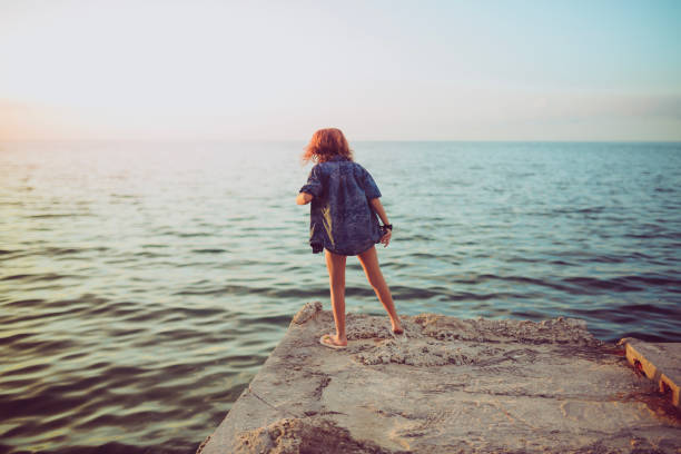 istock Child looking out on the water 1131205392