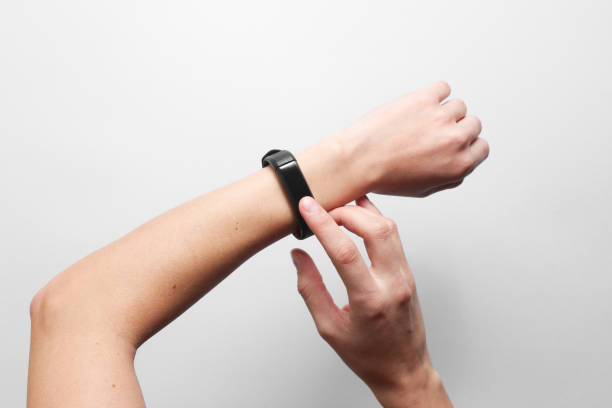 istock Women's hands use smart watch on gray background. Modern gadgets, top view 1131206352