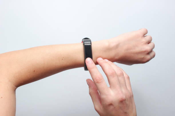 istock Women's hands use smart watch on gray background. Modern gadgets, top view 1131206372