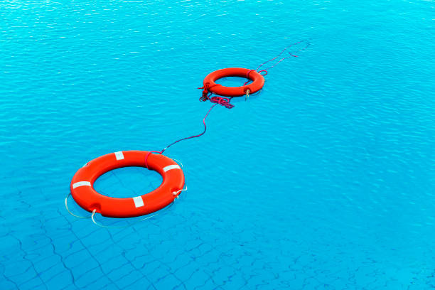 preservatori di vita di colore arancione galleggianti in piscina in grecia - life jacket isolated red safety foto e immagini stock