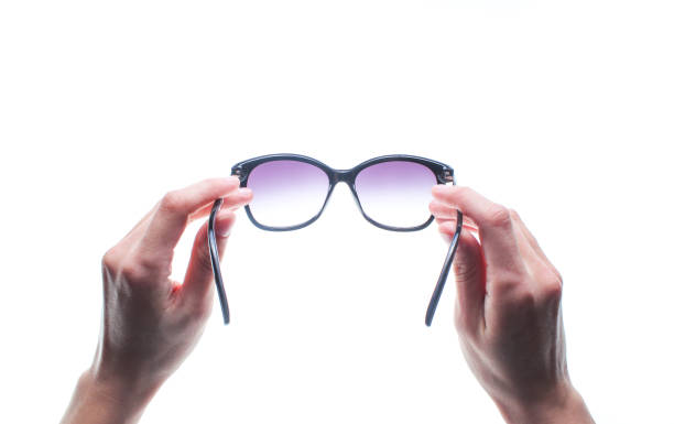 istock Hands holding sunglasses isolated on white background. 1131208398