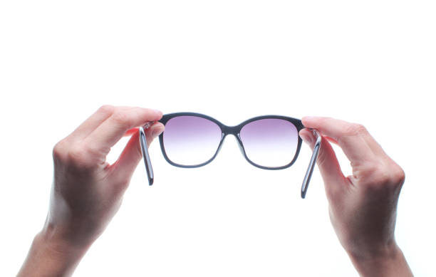istock Hands holding sunglasses isolated on white background. 1131208411